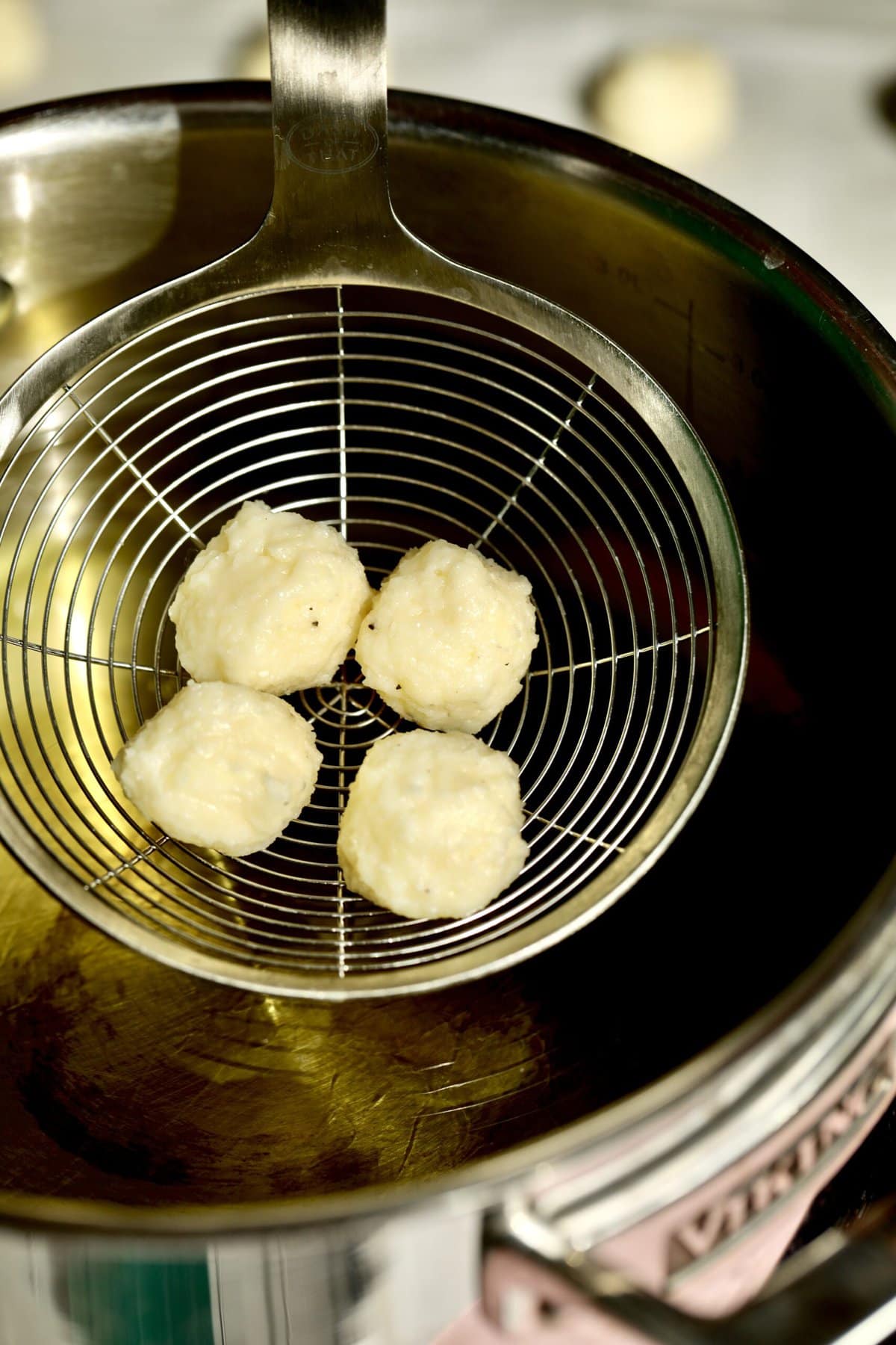 Process for making fried cheese balls- placing cheese balls in hot oil a few at a time.