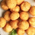 Easy Fried Cheese Balls Recipe (Crispy Bites) finished cheese balls on a plate.
