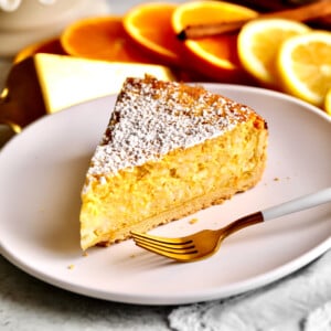 Slice of Italian Easter rice pie on a plate with a fork.