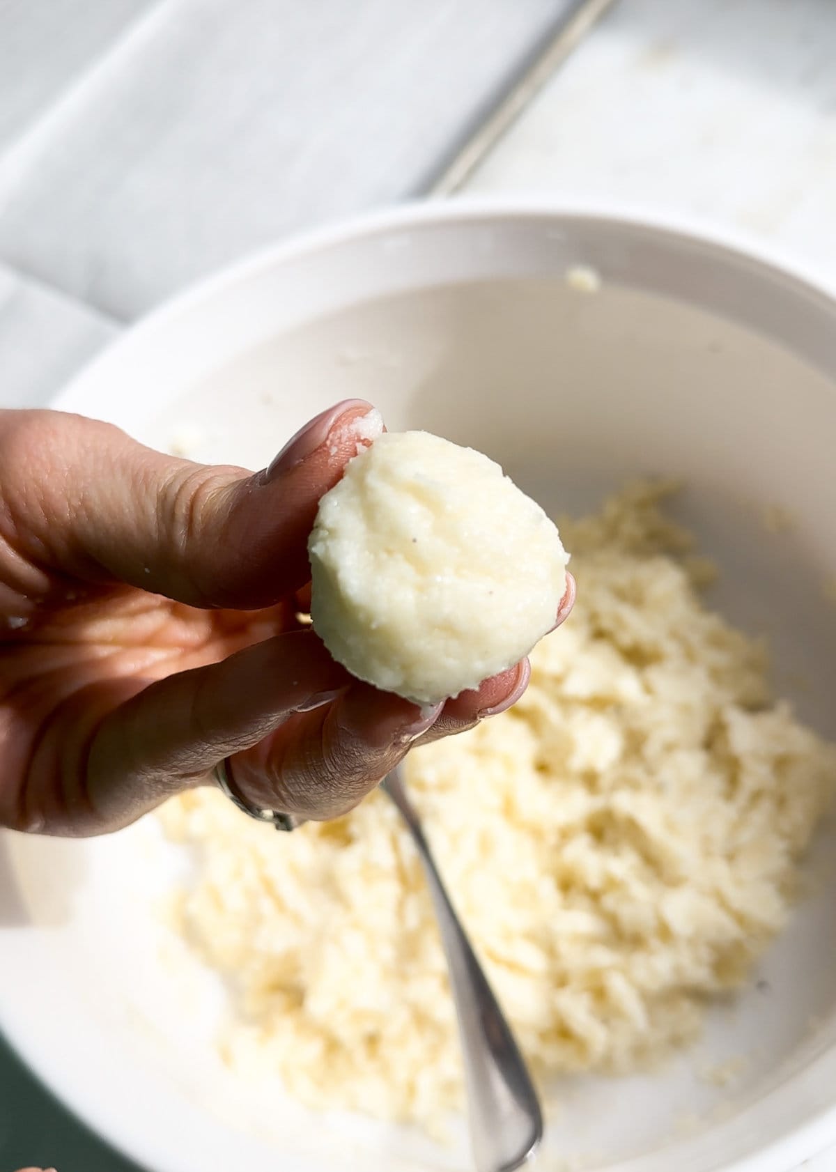 Process for making fried cheese balls-scooping up the cheese mixture with a small spoon and rolling it into a ball.