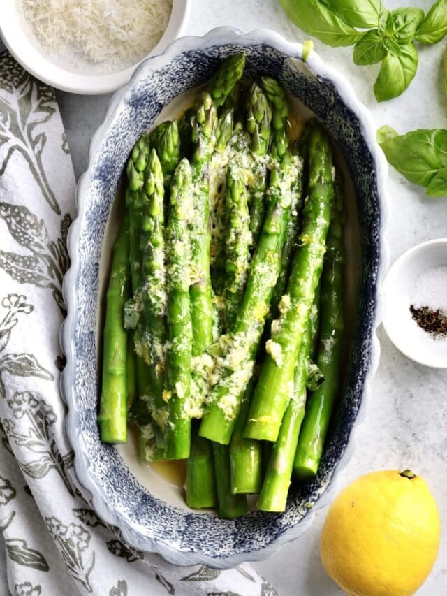 Finished steamed asparagus in a serving dish.