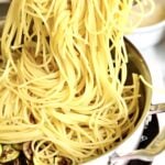 process for how to make spaghetti alla nerano- adding al dente pasta to the pan with fried zucchini and oil.