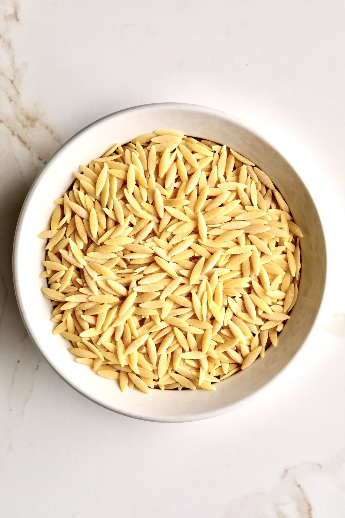 dry orzo pasta in a bowl.