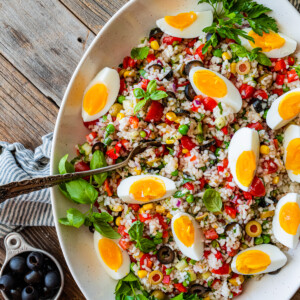 Spoon in a large serving bowl of Italian rice salad.
