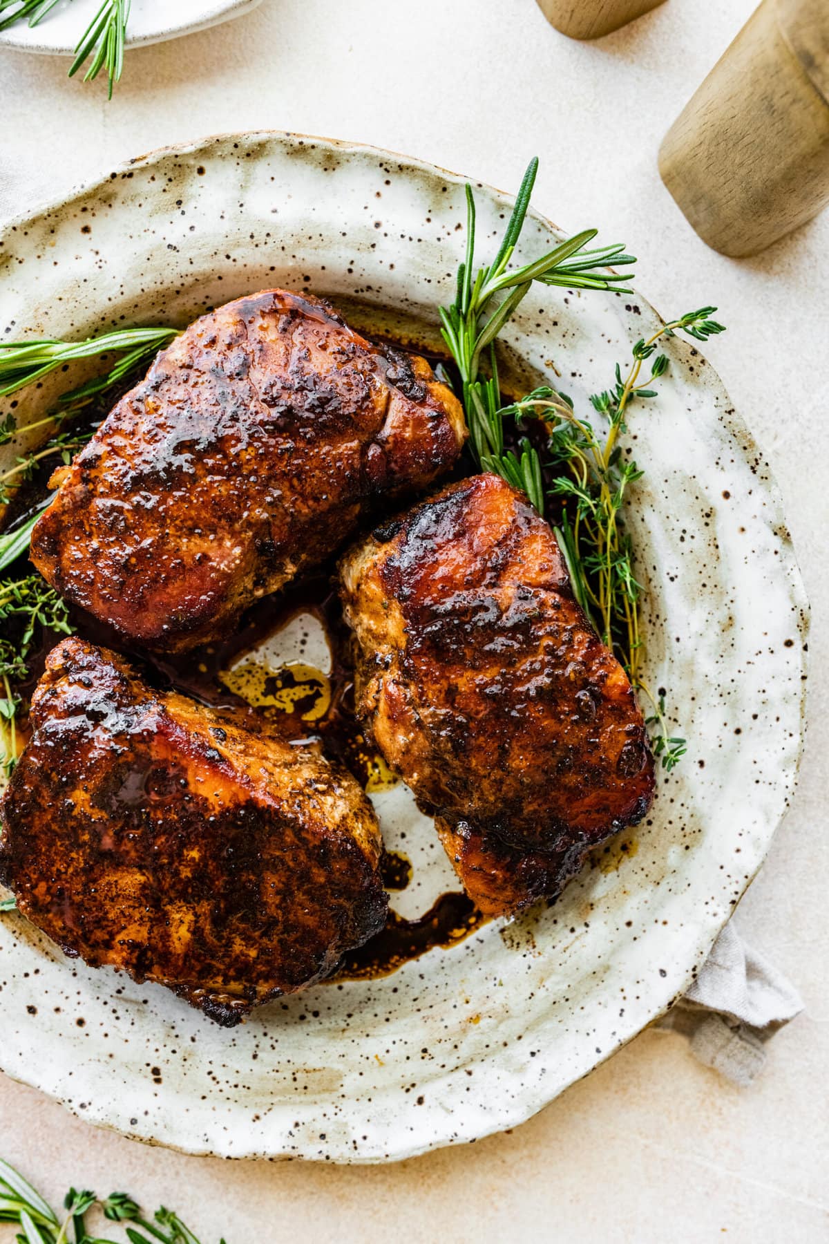 finished perfectly cooked pork chops on a white plate.