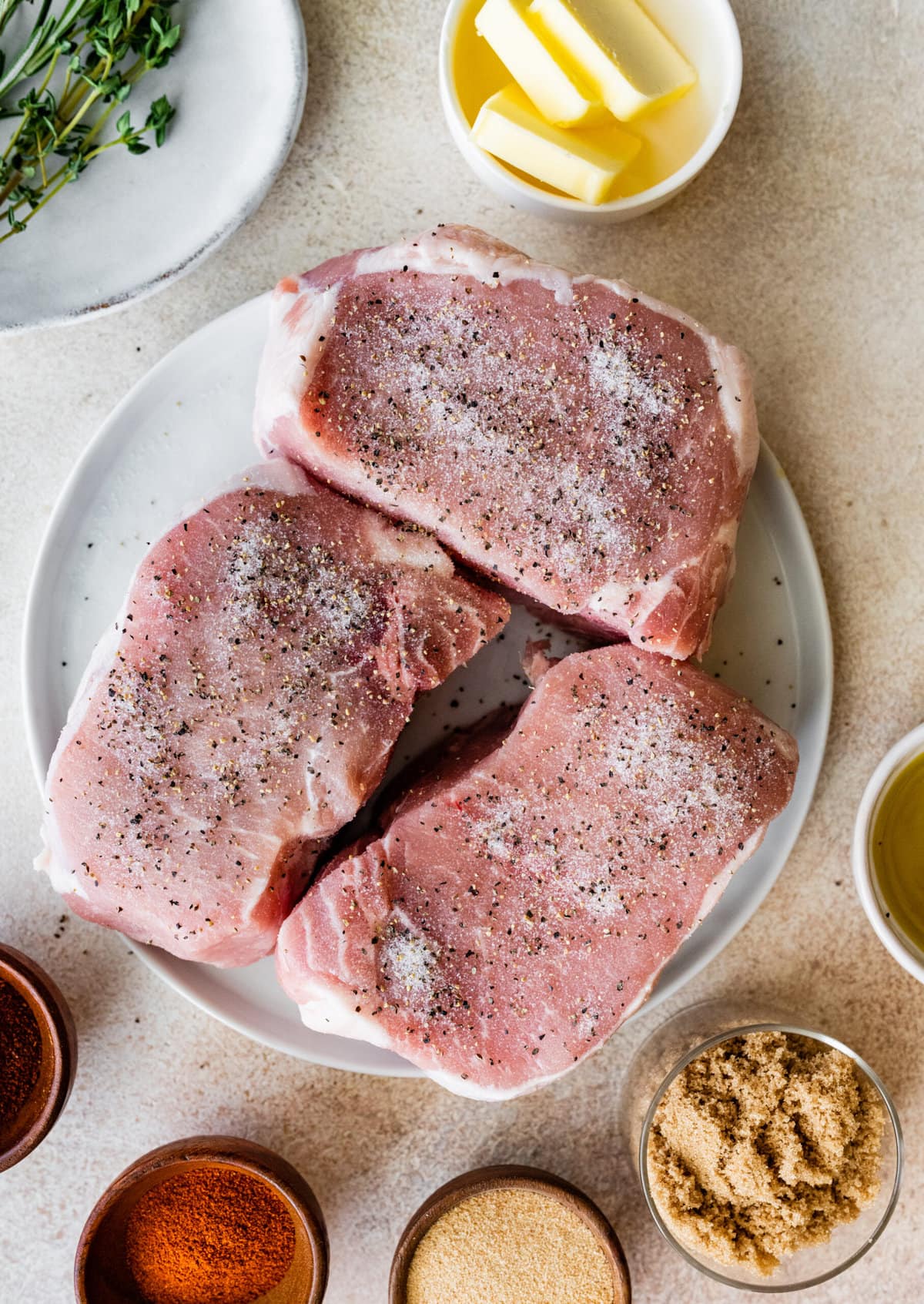 Step-by-step photos for How to cook thick pork chops- season both sides of the pork chops with salt and pepper.