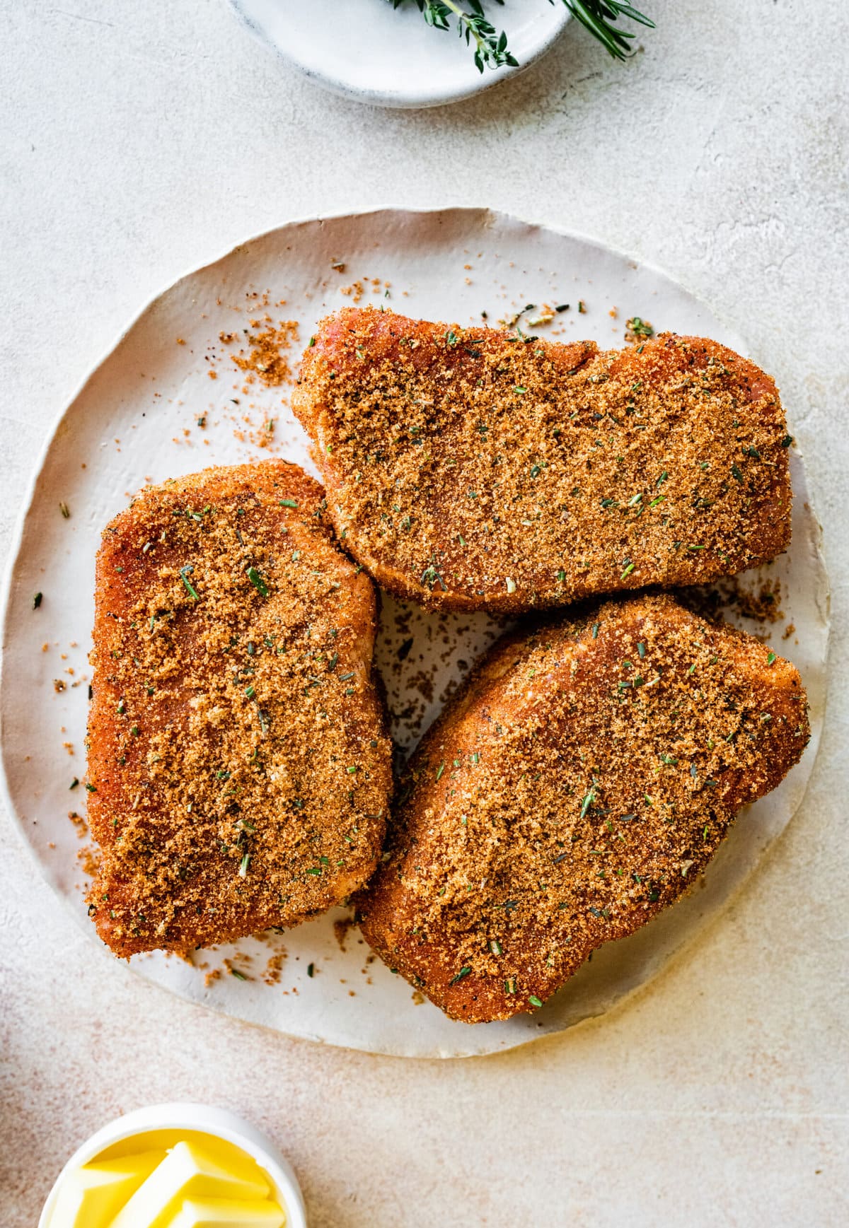 Step-by-step photos for How to cook thick pork chops- season pork chops with seasoning mix.