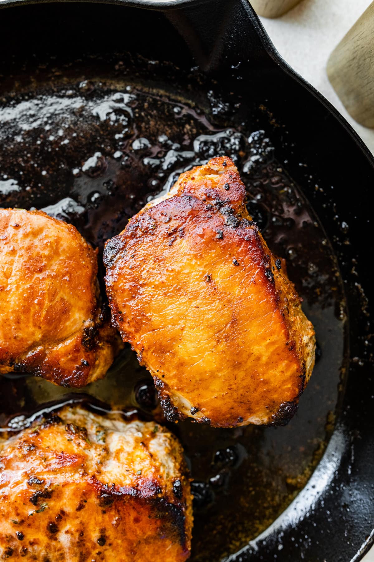 close up of pork chops in pan.