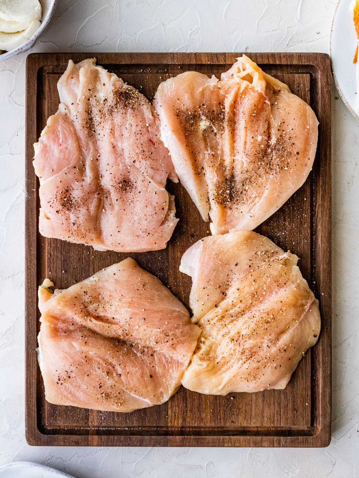 How to make Mozzarella stuffed Chicken chicken- slices of chicken cut open and seasoned with salt and pepper.