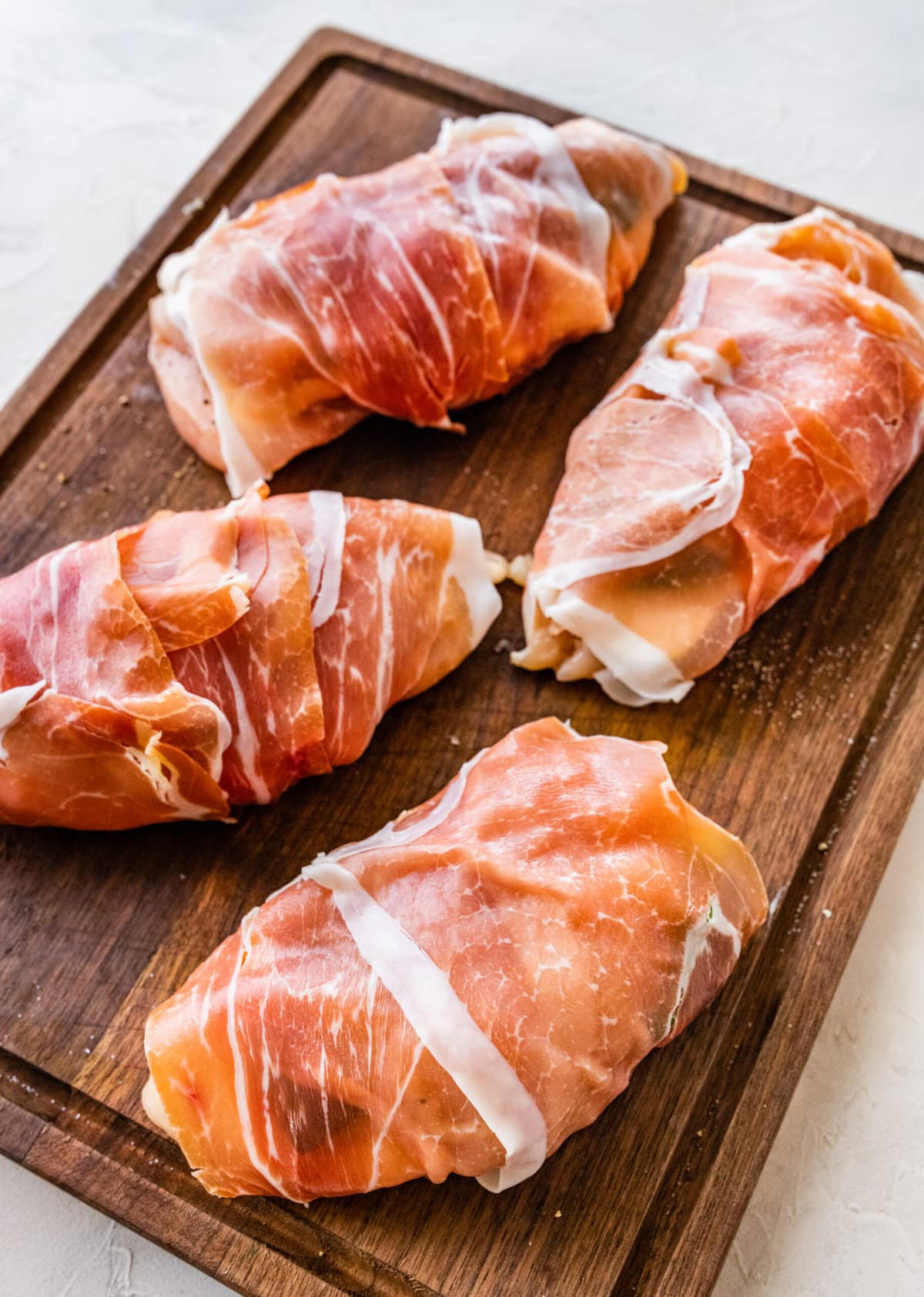 How to make Mozzarella stuffed Chicken chicken- stuffed chicken wrapped in prosciutto.