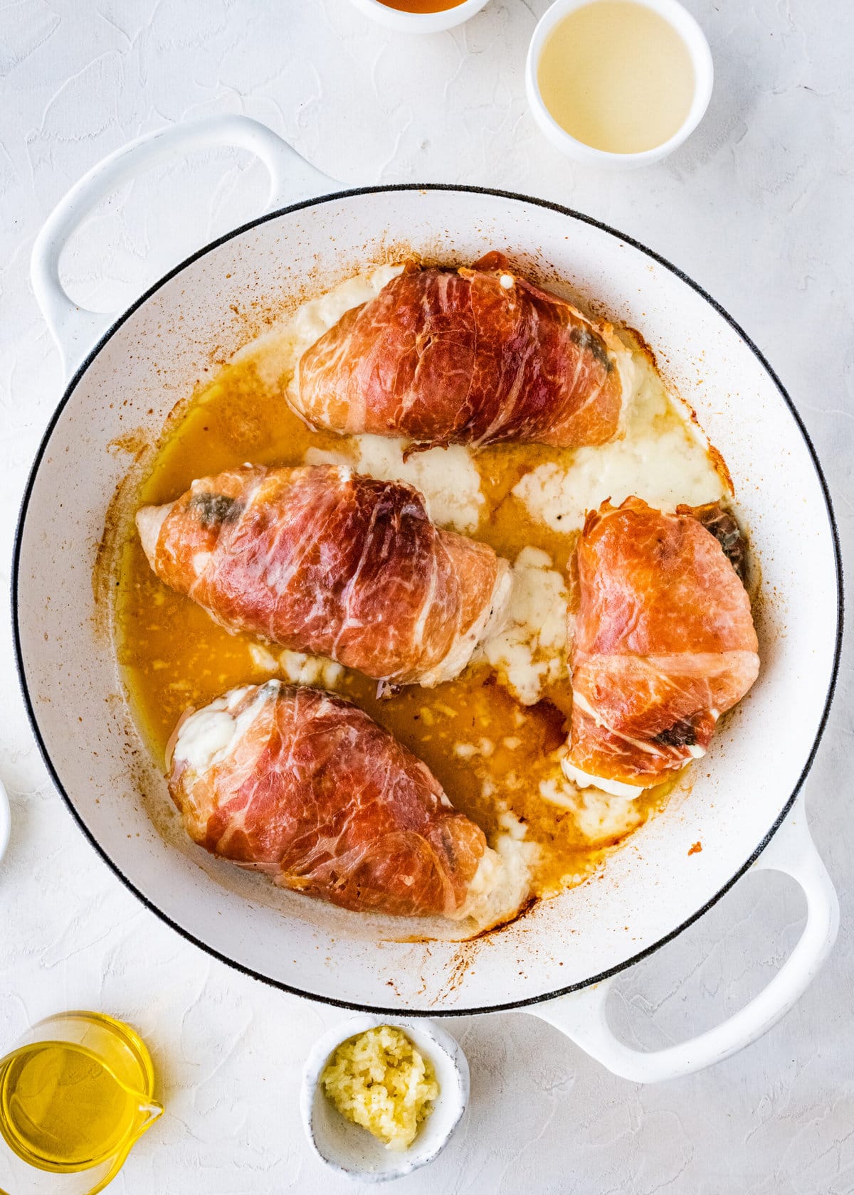 How to make Mozzarella stuffed Chicken chicken- stuffed chicken wrapped in parma ham placed in pan and browned on both sides. Finish baking in the oven.