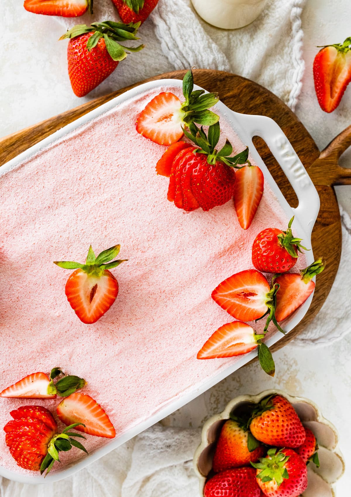 Best Strawberry Tiramisu Recipe (no egg). Final dish with strawberry powder for decoration and fresh cut strawberries on top.