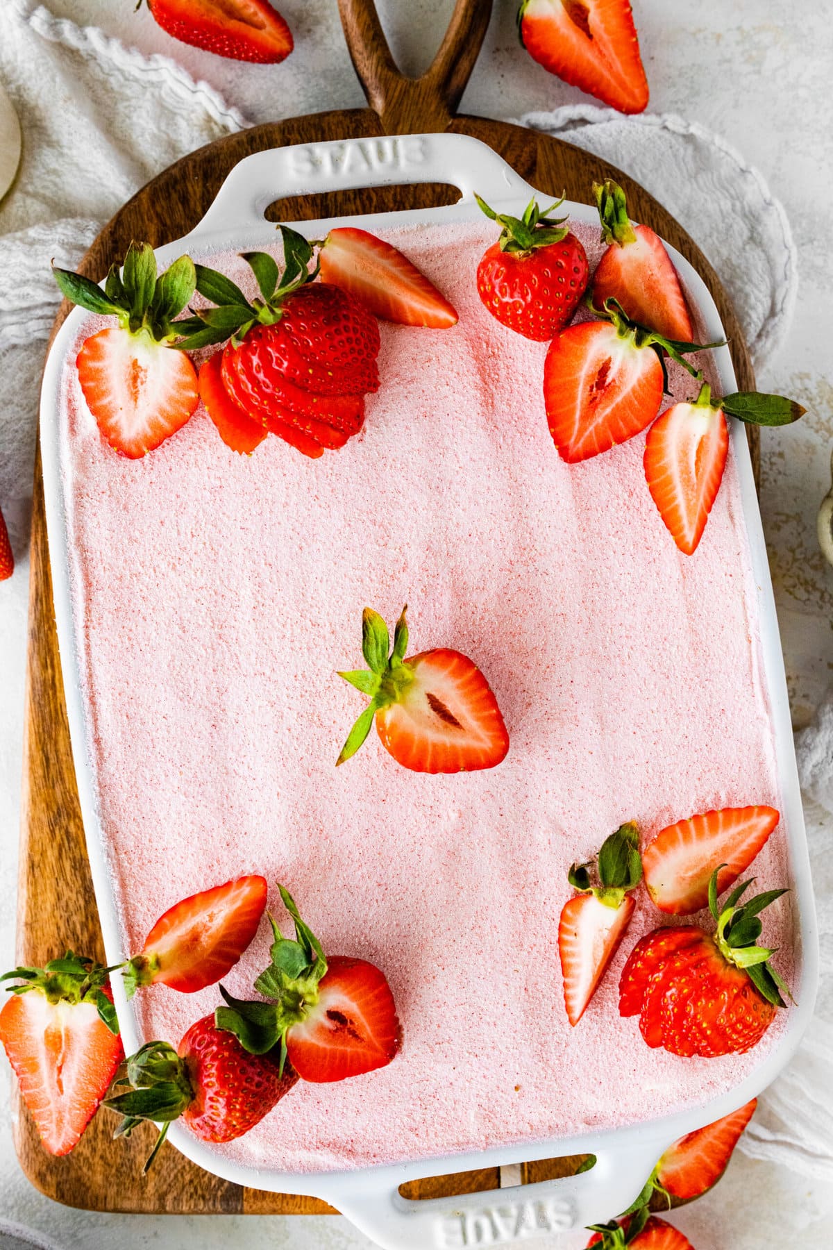 Best Strawberry Tiramisu Recipe (no egg). Final dish with strawberry powder for decoration and fresh cut strawberries on top.