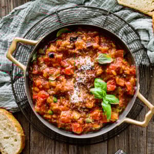 Italian sauteed eggplant with tomatoes in a pan.