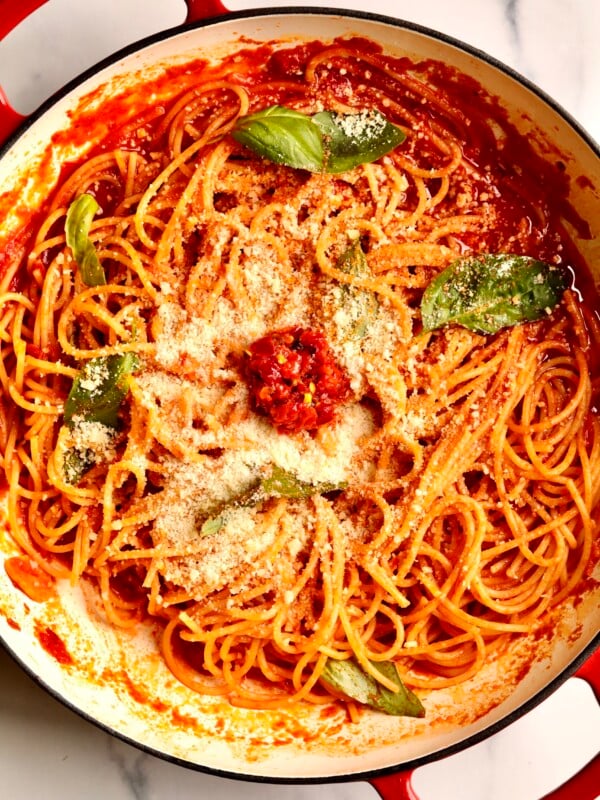 Tomato Paste Pasta topped with fresh basil and cheese.