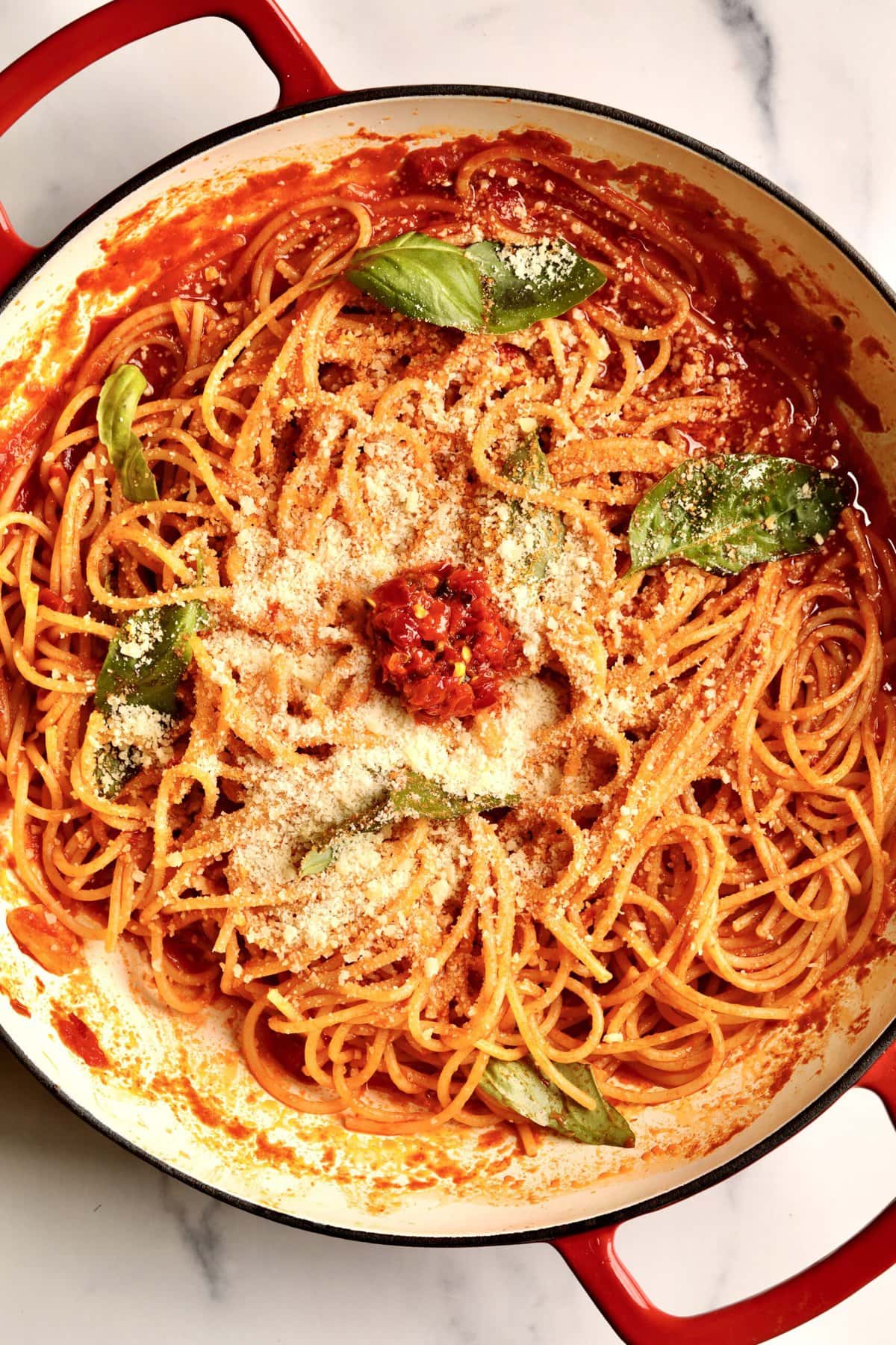 How to make: Quick Tomato Paste Pasta Sauce Recipe with Spaghetti- add the al dente pasta to the pan with the pasta sauce and stir to combine. Add fresh basil and toss. Add extra cheese and Calabrian chili paste if desired.