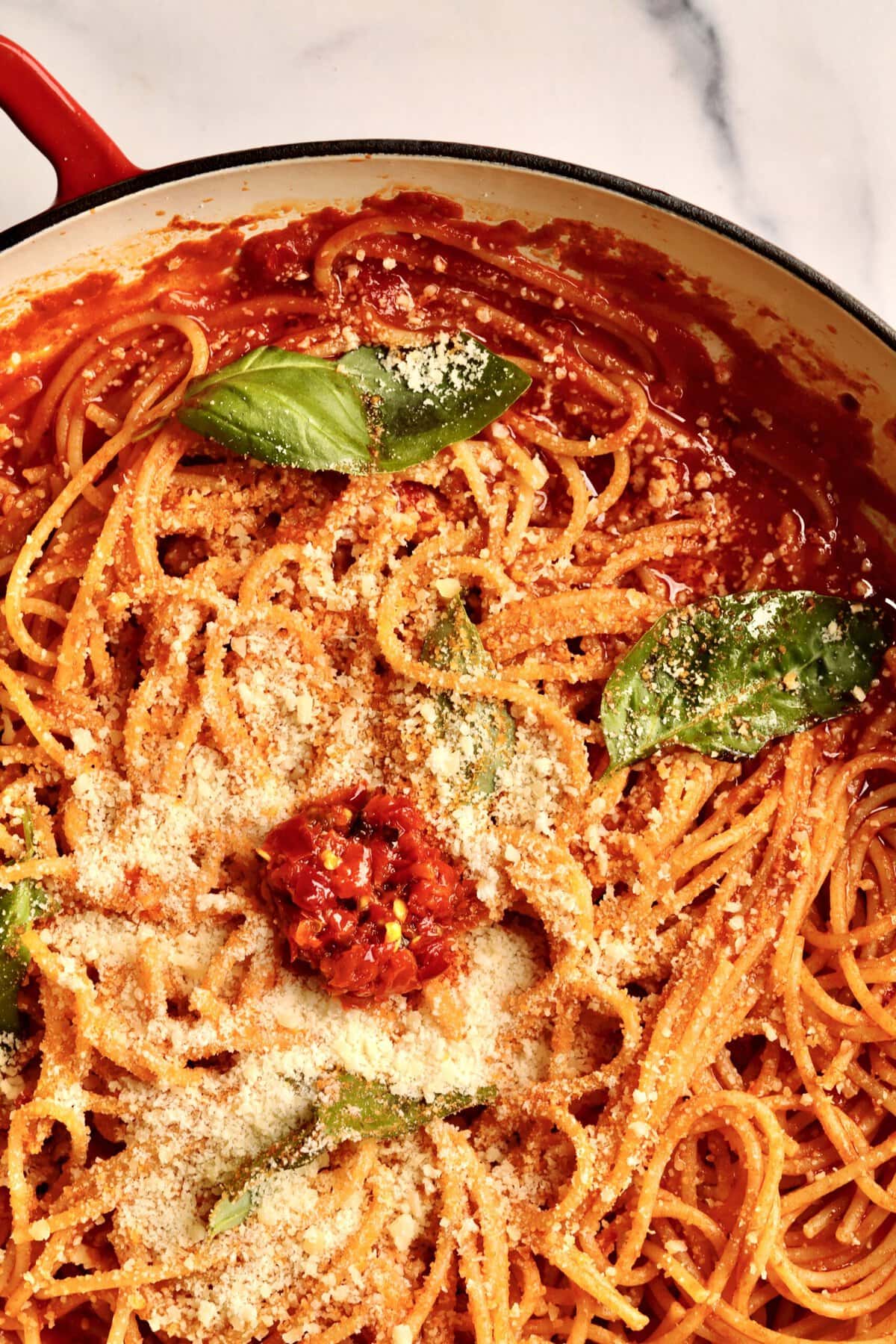 How to make: Quick Tomato Paste Pasta Sauce Recipe with Spaghetti- add the al dente pasta to the pan with the pasta sauce and stir to combine. Add fresh basil and toss. Add extra cheese and Calabrian chili paste if desired.