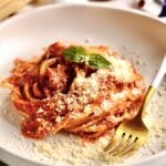 Quick Tomato Paste Pasta Sauce Recipe with Spaghetti on a plate with a fork.