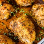 How Long to Bake Chicken Thighs at 375 (Best Recipe)- baked chicken in a pan with pan juices. Fresh herbs on top.