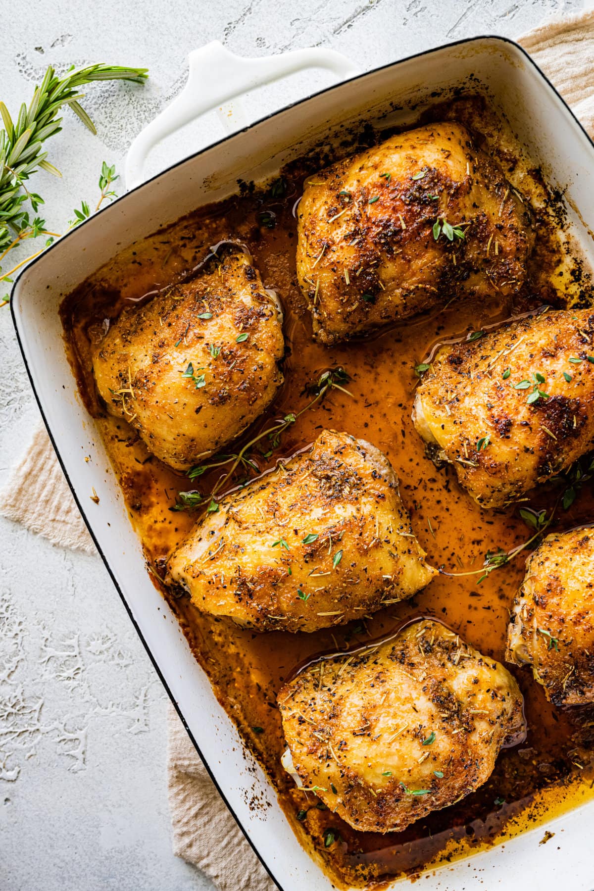 How Long to Bake Chicken Thighs at 375 (Best Recipe)- baked chicken in a pan with pan juices.