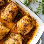 How Long to Bake Chicken Thighs at 375 (Best Recipe)- baked chicken in a pan with pan juices.