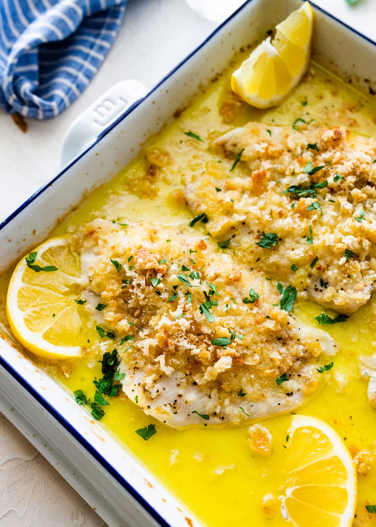 Baked Flounder Recipe with Lemon- fish with sauce after it is baked. Serve with lemon wedges.