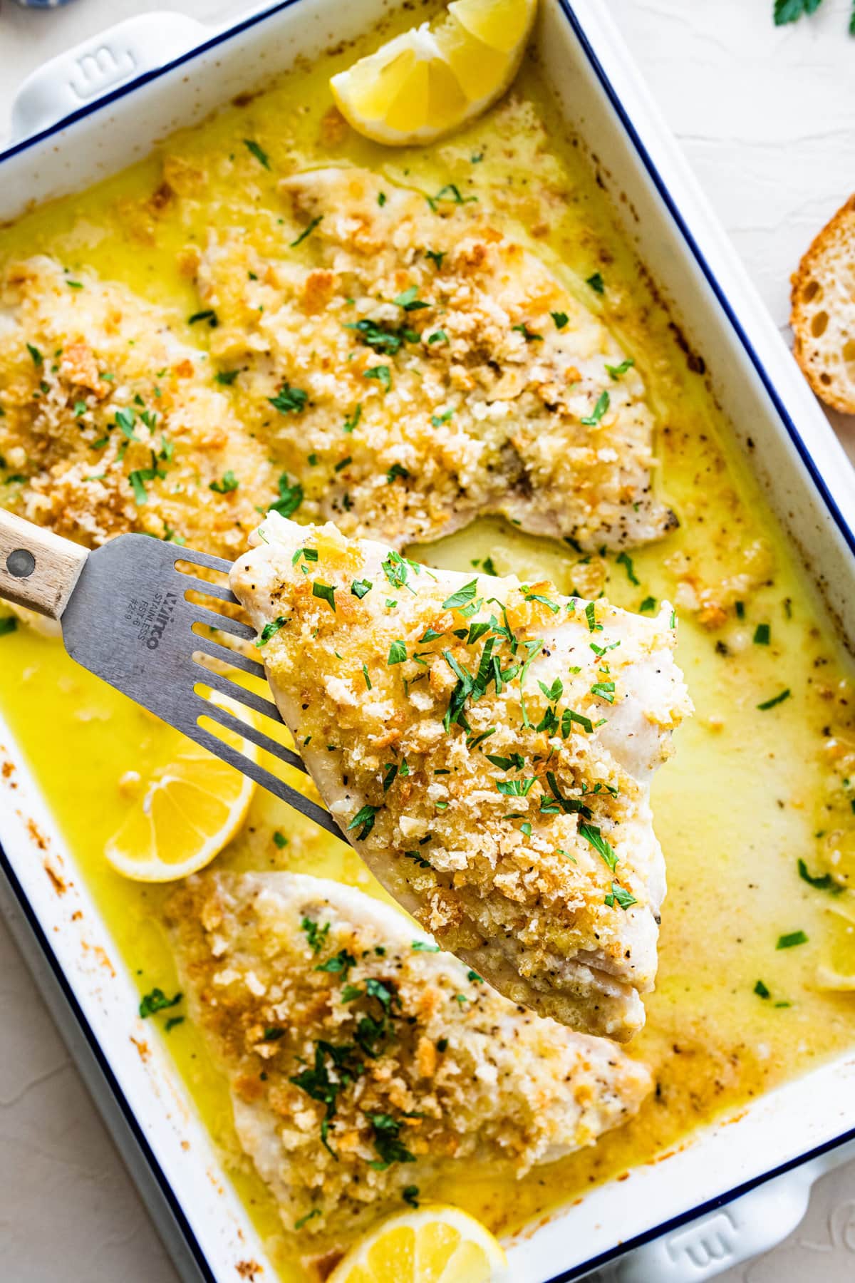 spatula holding the fish for an up close view. Sprinkle parsley over the top.