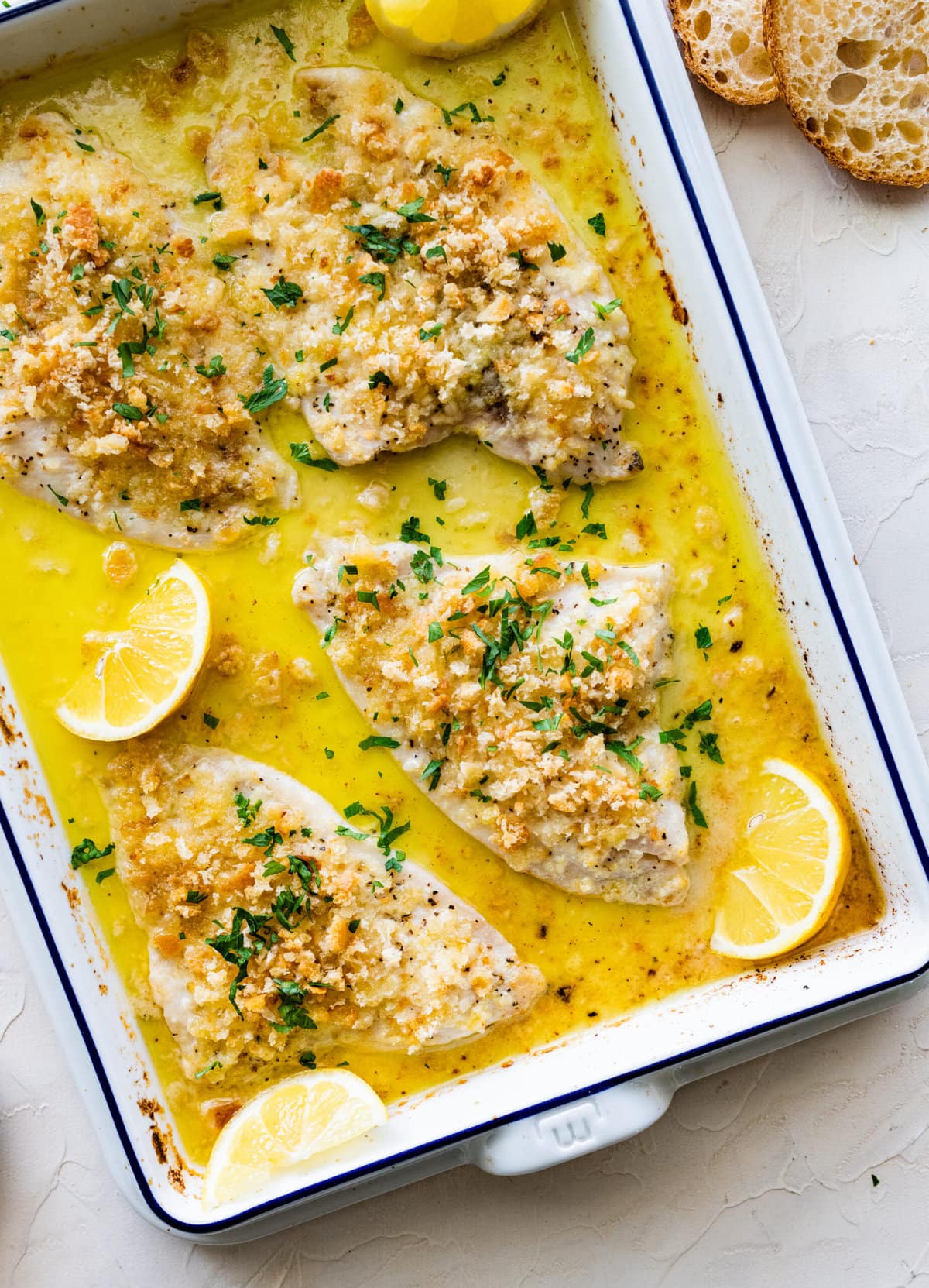 Baked Flounder Recipe with Lemon- fish with sauce after it is baked. Serve with lemon wedges.