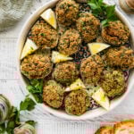 Cover image. Best Italian Baked Stuffed Clams on a plate with lemon wedges and parsley.