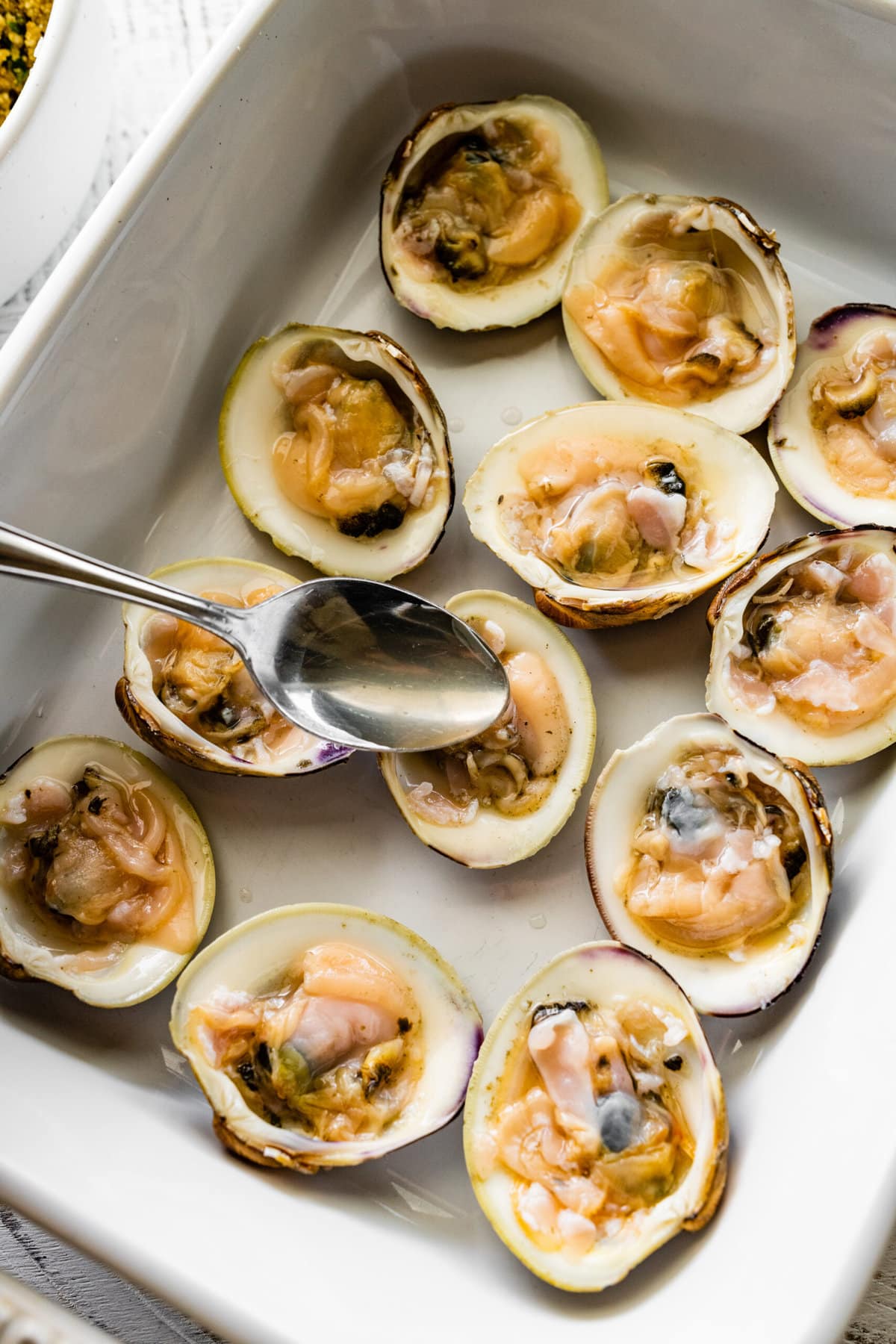 How to make- Best Italian Baked Stuffed Clams- add clam juice on clams.