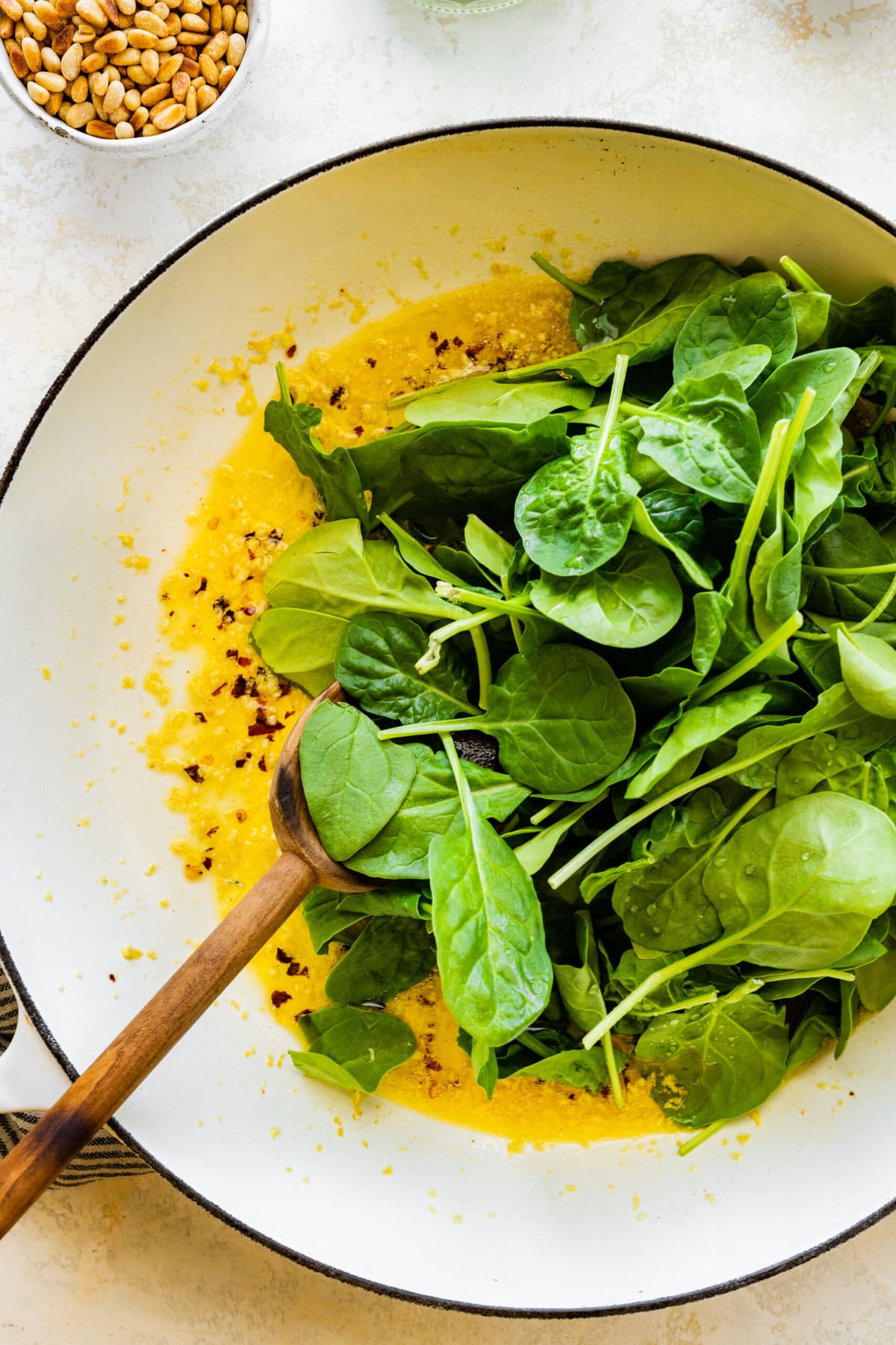 How to make- Easy Pasta with Sautéed Spinach and Garlic- adding fresh spinach to pan.