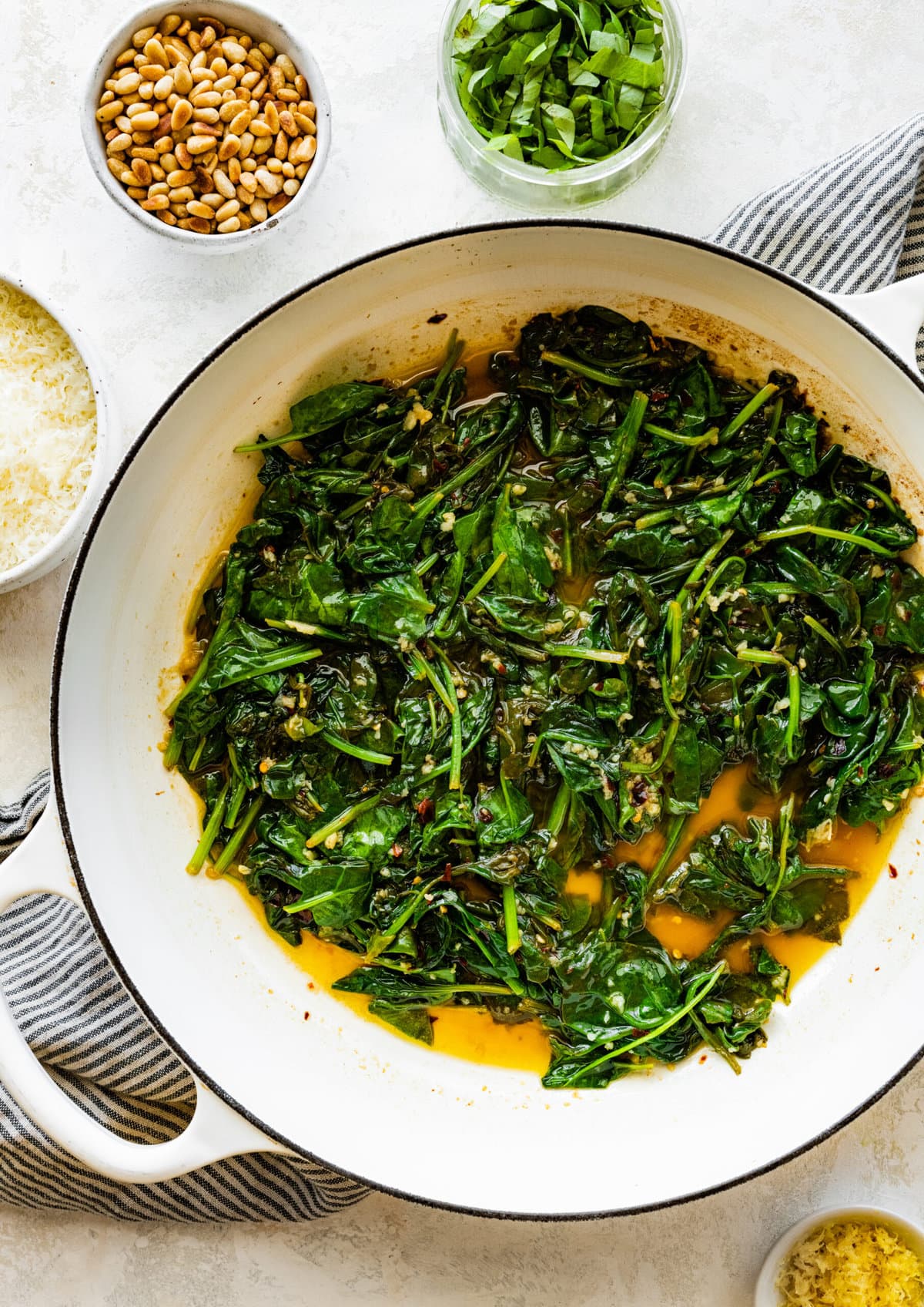 How to make- Easy Pasta with Sautéed Spinach and Garlic- letting spinach cook in pan with olive oil and herbs.