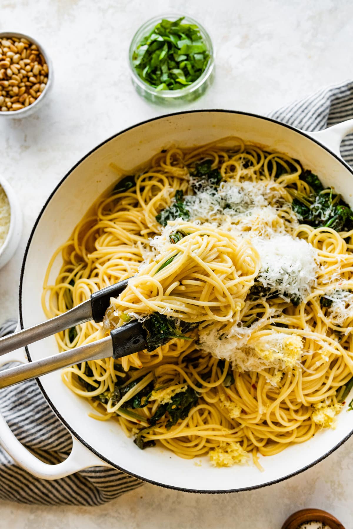 How to make- Easy Pasta with Sautéed Spinach and Garlic- tossing the pasta and adding the cheese.