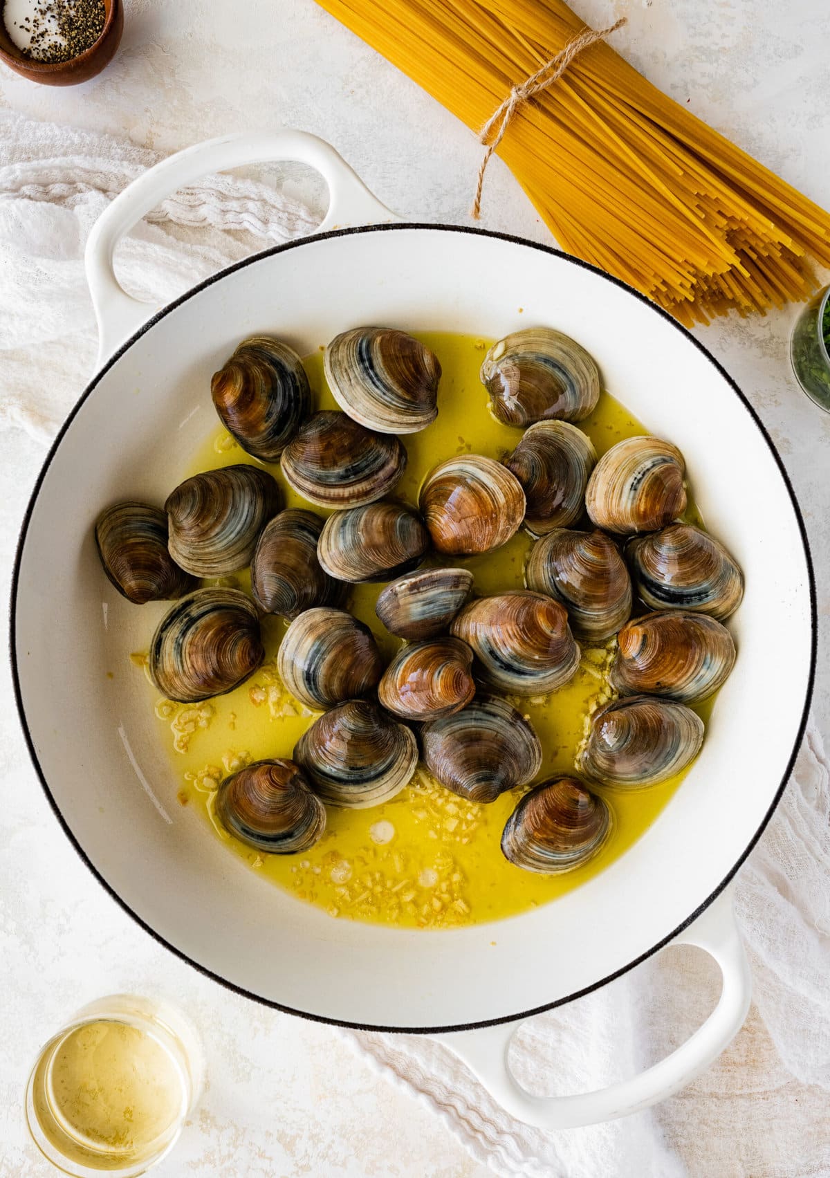 How to make- Spaghetti alle Vongole Recipe (Pasta with Clams)- adding the clams to the pan with olive oil.