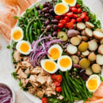 Tuna Nicoise Salad Recipe with Easy Vinaigrette- making the vinaigrette. Adding all ingredients to a large serving platter.
