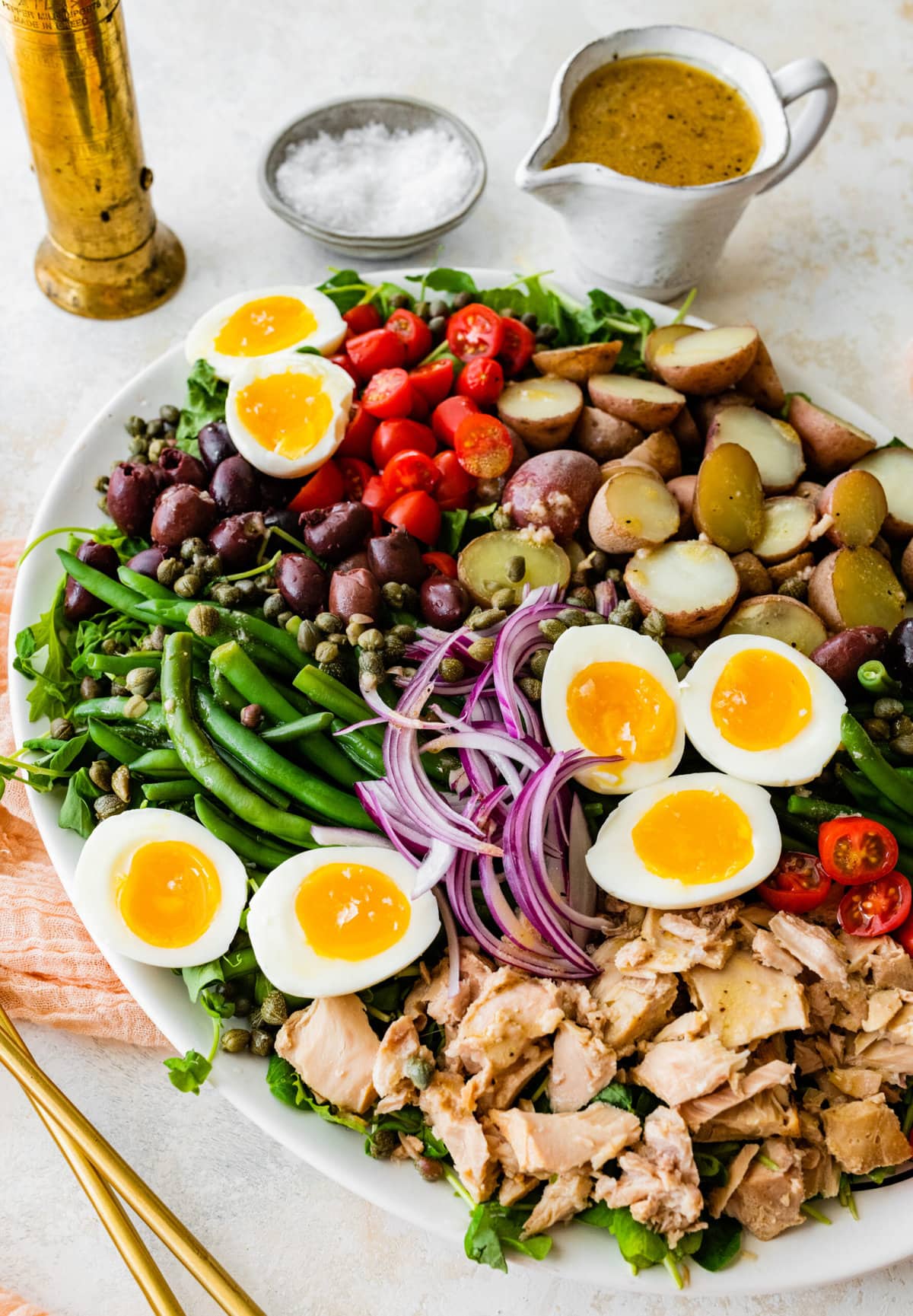 Tuna Nicoise Salad Recipe with Easy Vinaigrette- making the vinaigrette. Adding all ingredients to a large serving platter. 