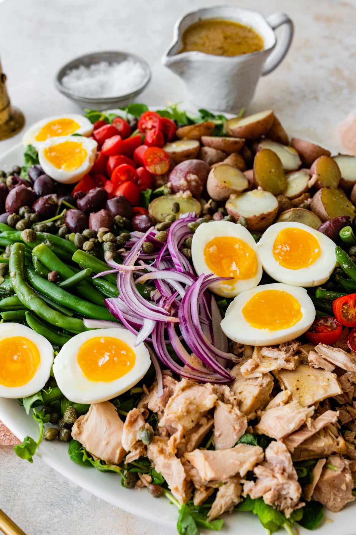 Tuna Nicoise Salad Recipe with Easy Vinaigrette- making the vinaigrette. Adding all ingredients to a large serving platter.