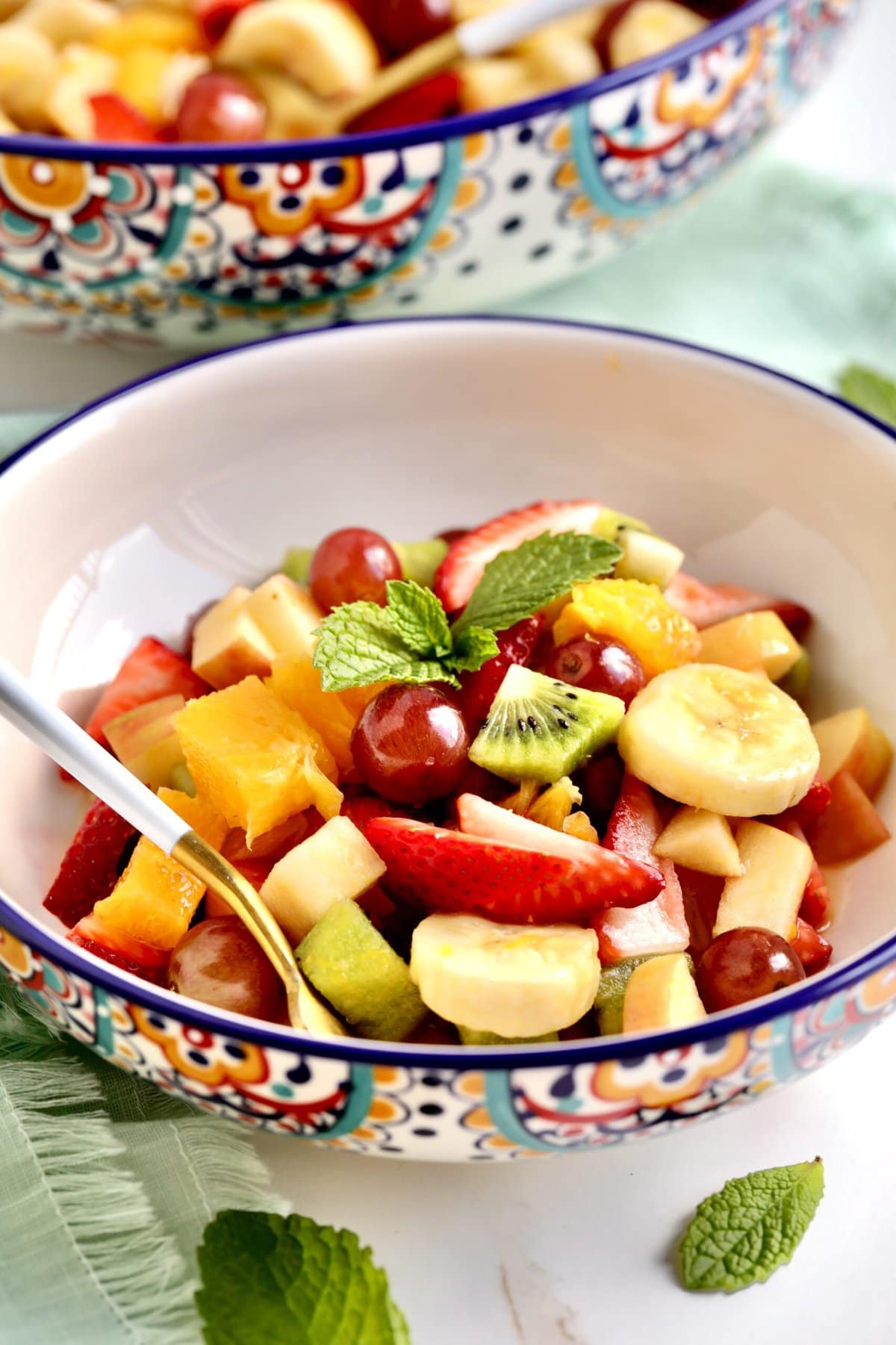 Italian Fruit Salad Recipe (Macedonia di Frutta)- in a bowl with a fork in it ready to eat.