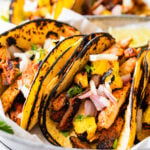 Homemade Tacos Al Pastor Recipe (Tacos De Trompo)- assembled tacos on a plate ready to eat.