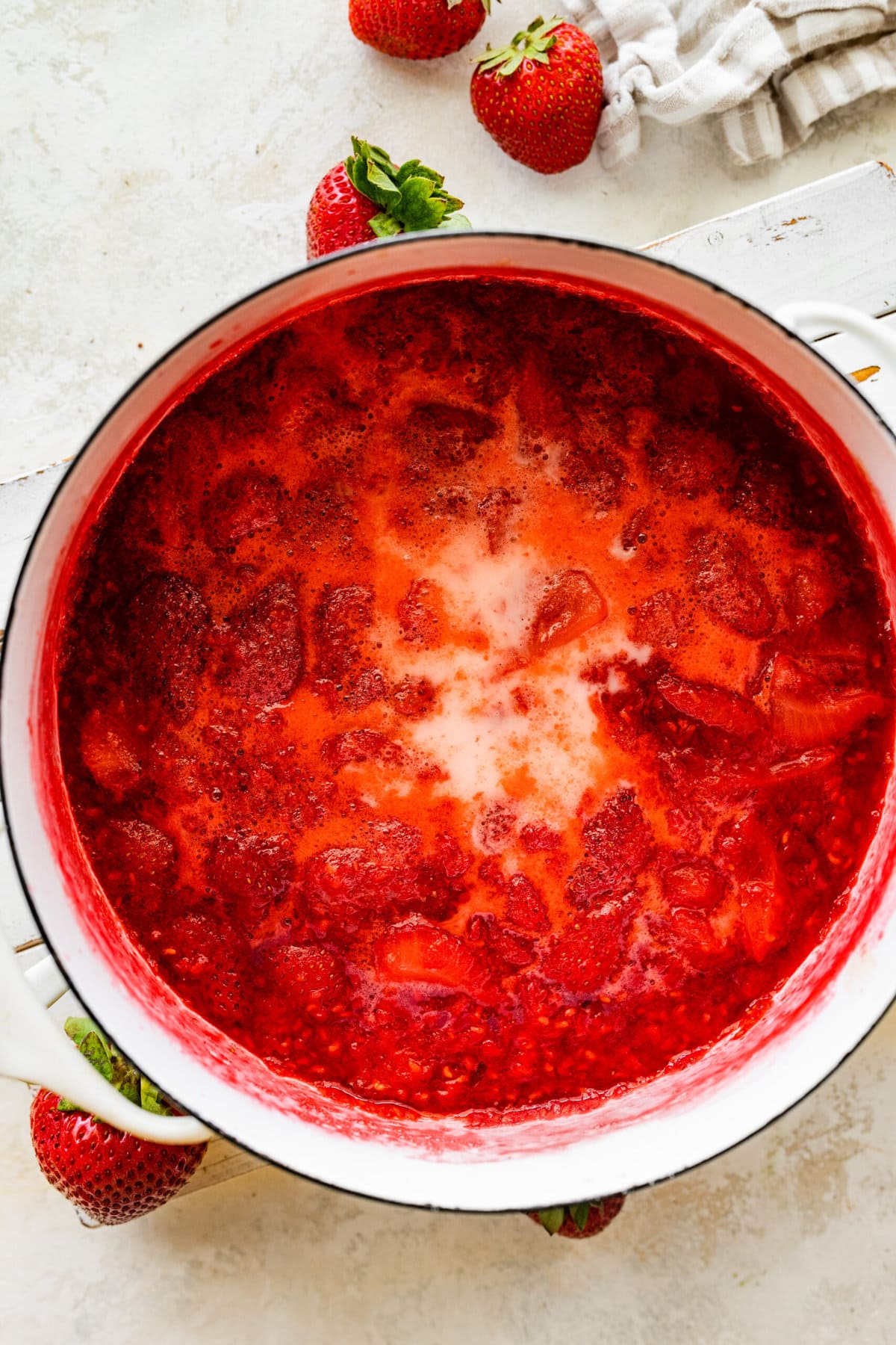 Making the berry puree. Adding the sugar and berries in a pot. Cooking sugar and berries.