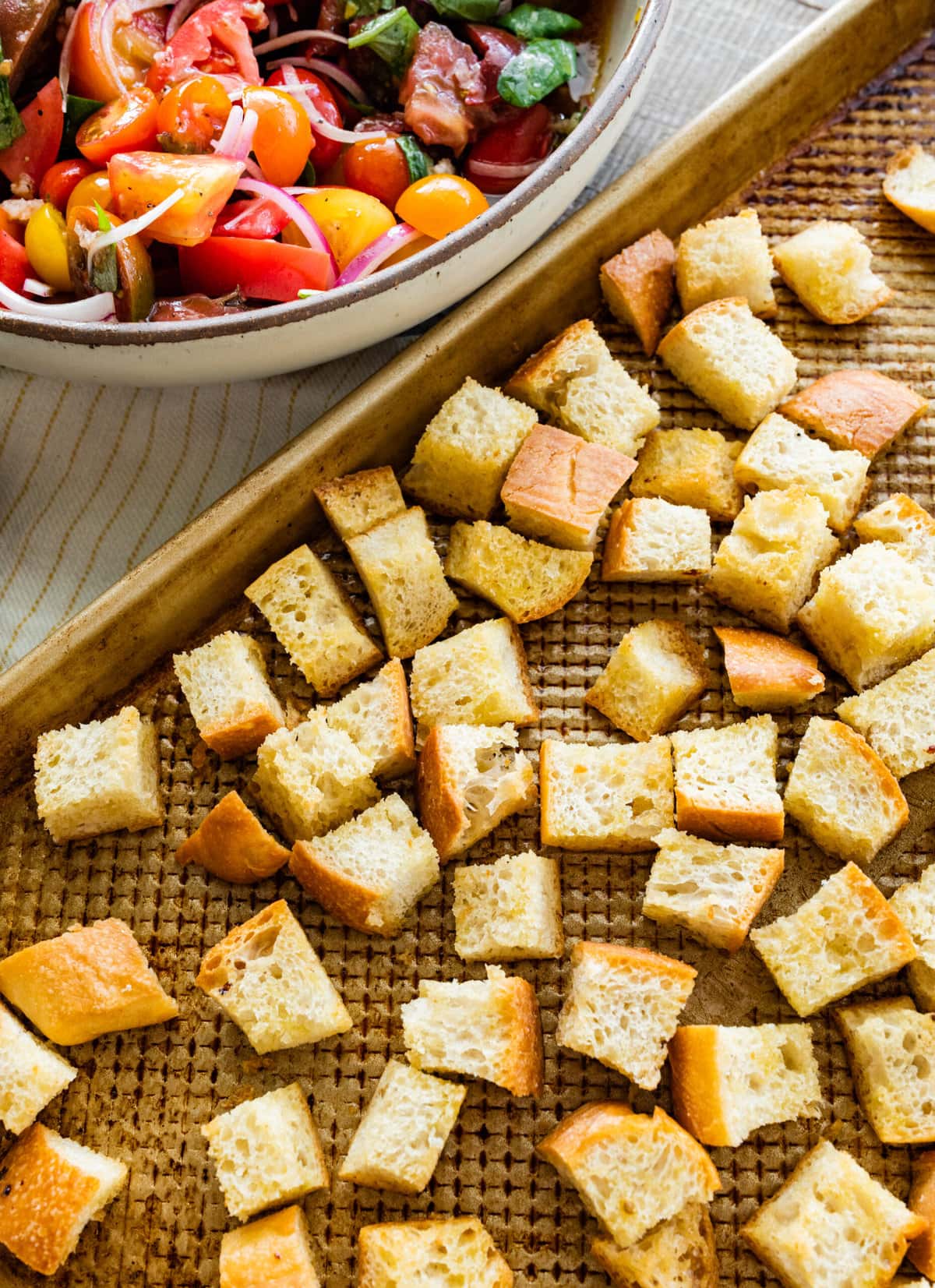 Best Summer Panzanella Salad Recipe (Bread & Tomato)- toasting the bread on a cookie sheet.
