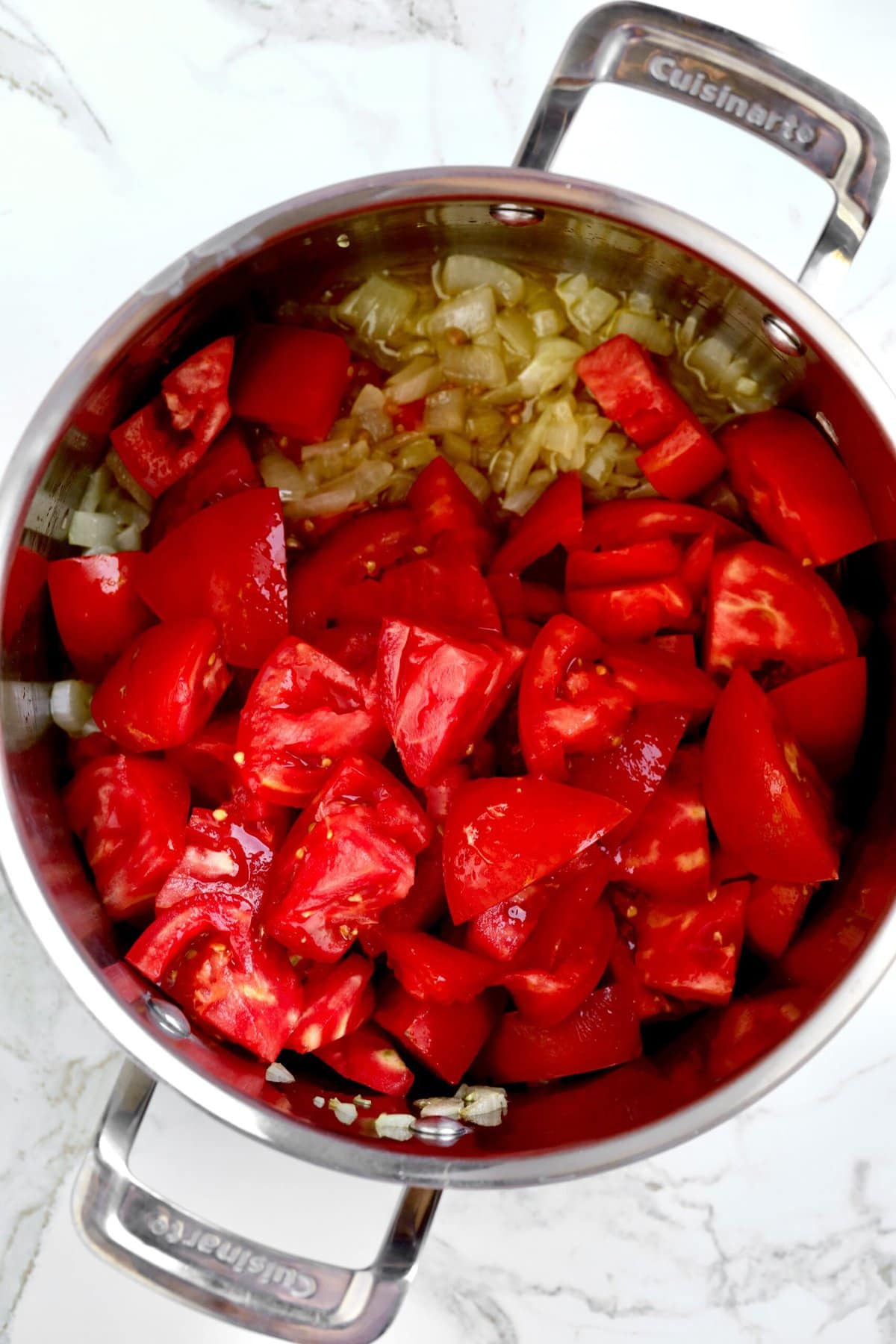 How to Homemade Marinara Sauce Recipe with Fresh Tomatoes- olive oil and onions stewing then add tomatoes.