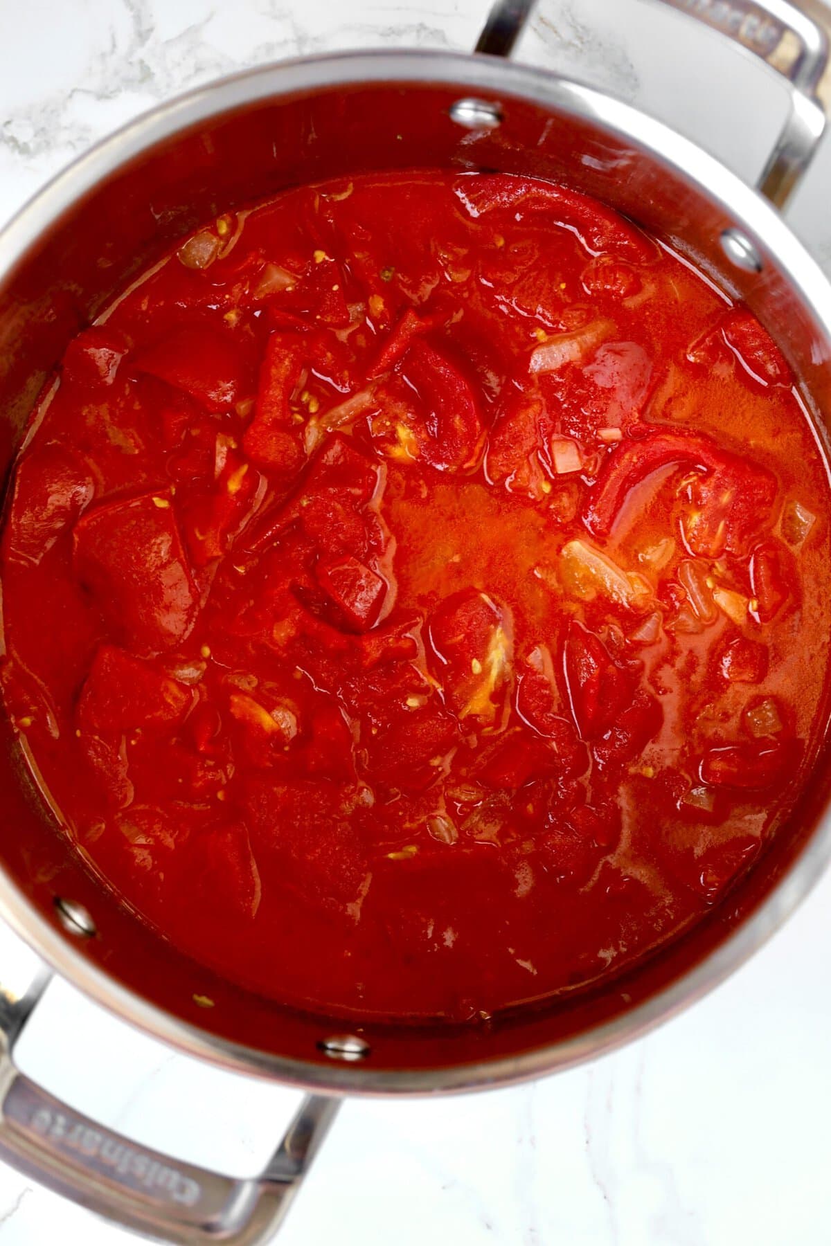 How to Homemade Marinara Sauce Recipe with Fresh Tomatoes- let tomatoes and onions sew for 30 minutes.