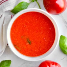 Bright red marinara sauce in a white bowl.