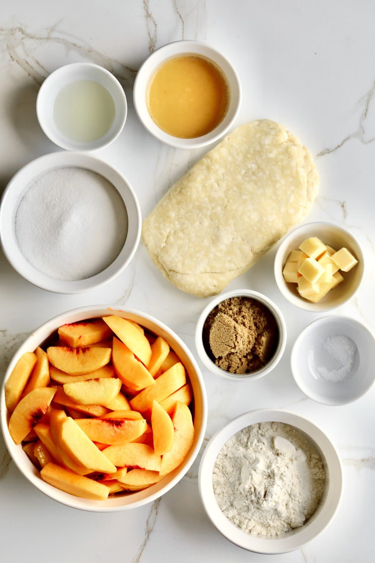 Fresh peach pie ingredients including light brown sugar, flour, and salt.