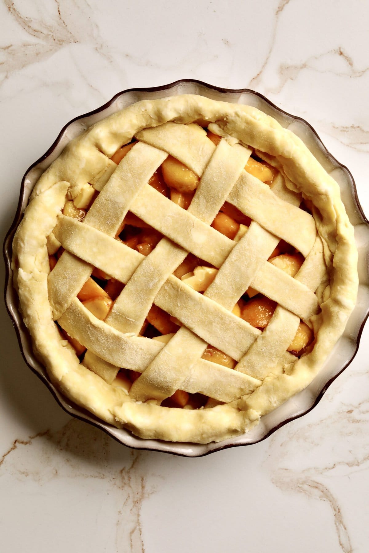 How to make fresh peach pie recipe step-by-step: making lattice top as final layer of peach pie.