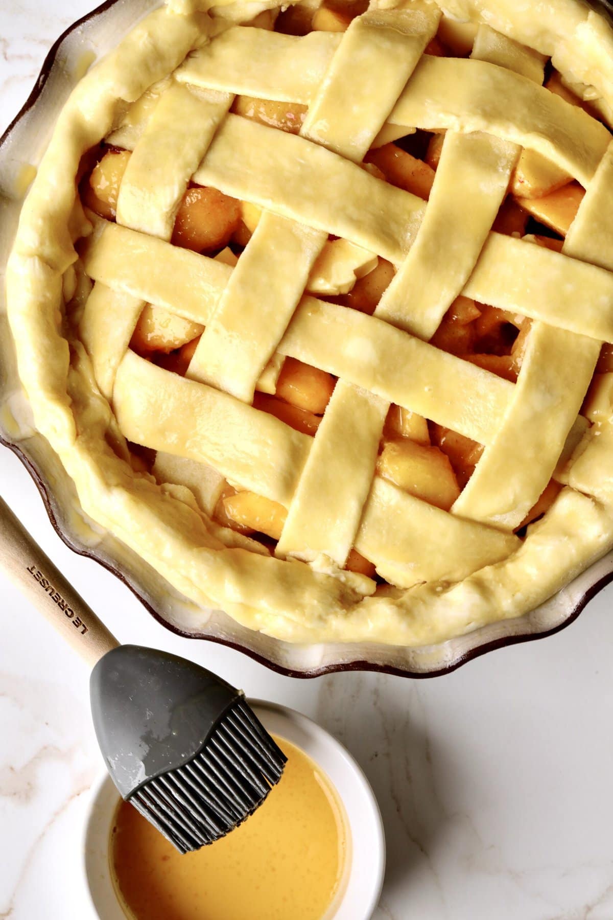 How to make fresh peach pie recipe step-by-step: egg wash for the pie ready to bake.