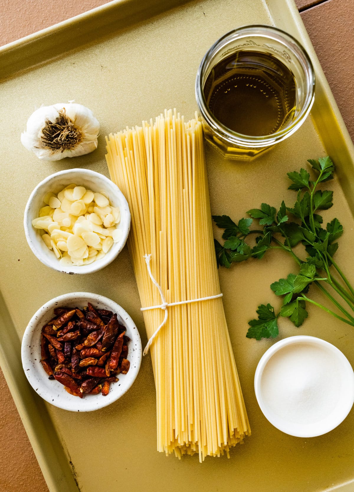 Spaghetti aglio e olio ingredients including noodles, garlic, and oil.