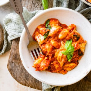 Fork in a bowl with baked gnocchi alla sorrentina.