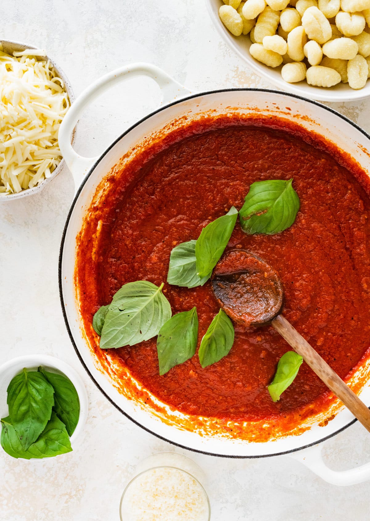 How to make gnocchi all sorrentina step-by-step- adding tomato sauce and cooking. Adding basil leaves.